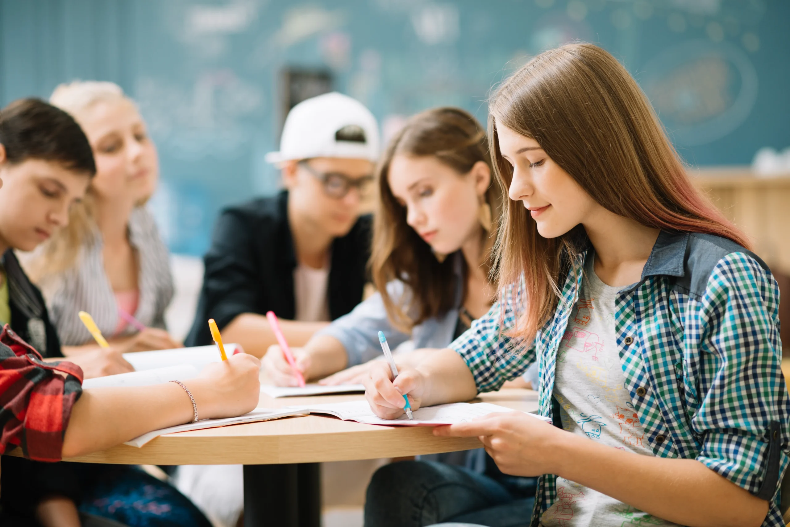 Students taking paper tests at table