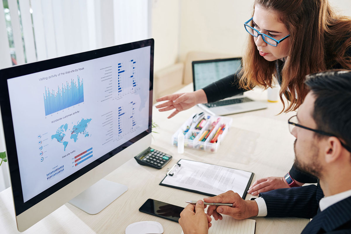 business-people-discussing-statistics-YBST5LR
